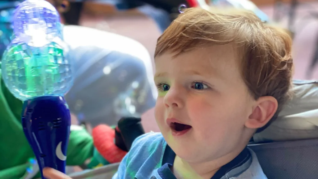 Baby enjoying bubble wand at Disney World