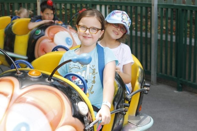 Kids riding Busy Bess in Country Fair section of Dollywood theme park